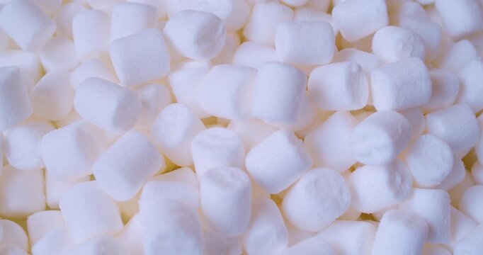 Close-up of many pieces of White Marshmallow. Sweet food. Macro with shallow depth of field.