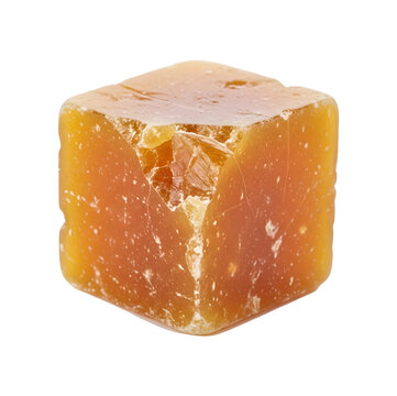Single cube of raw organic jaggery palm sugar isolated background