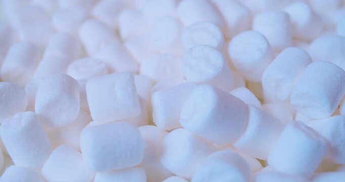 Close-up of many pieces of White Marshmallow. Sweet food. Macro with shallow depth of field.
