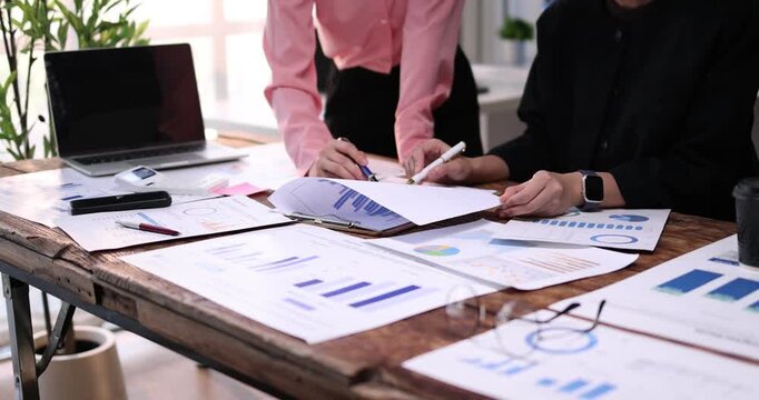 Business team working at office, using calculator to calculate company finance, accounting with laptop computer on table, budget management. Doing finance, budgeting and tax calculation