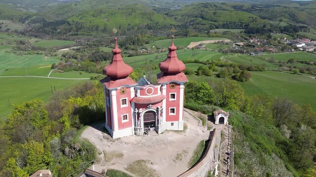 Aerial view circling the baroque Calvary church complex in Banska Stiavnica, a UNESCO World Heritage site, revealing its unique architecture