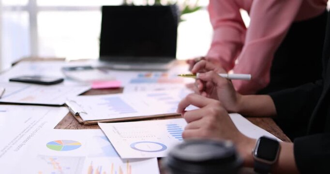 Business team working at office, using calculator to calculate company finance, accounting with laptop computer on table, budget management. Doing finance, budgeting and tax calculation
