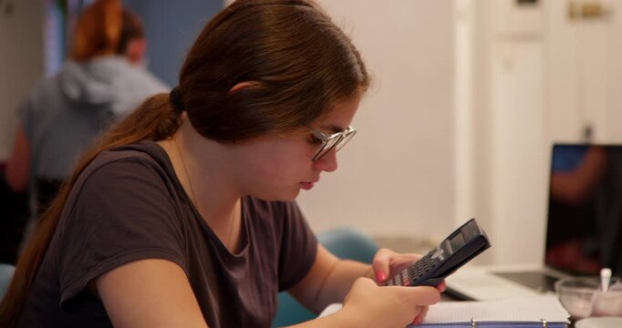 Focused Calculation: A young student diligently working on a calculation, engrossed in a focused moment of learning.