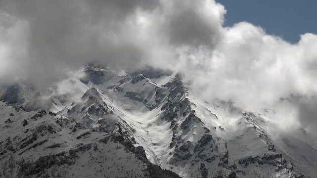Snowy Peru peaks beneath storm clouds in Cordillera Blanca and Huayhuash, dramatic Andes. Glaciated summits, highland weather, rugged skyline, remote range, powerful mountain panorama.