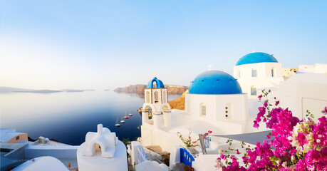 traditional greek village Oia of Santorini, with blue domes against sea and caldera, Greece, web banner format © neirfy