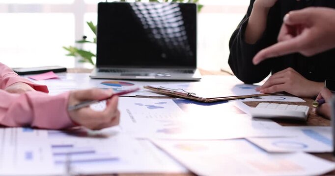 Business team working at office, using calculator to calculate company finance, accounting with laptop computer on table, budget management. Doing finance, budgeting and tax calculation