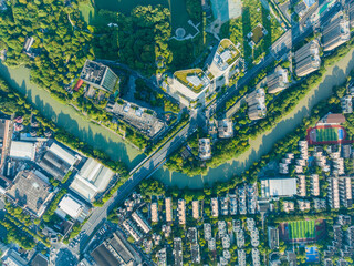 Aerial view of Hangzhou city district with winding river and green urban landscape © VuDieu