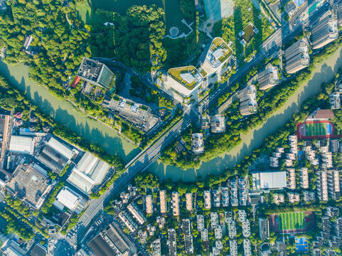 Aerial view of Hangzhou city district with winding river and green urban landscape