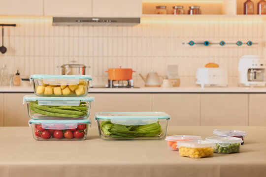 Fresh vegetables in airtight glass containers on kitchen counter
