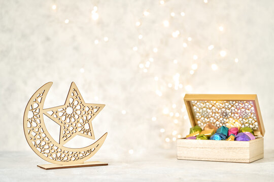 Colorful chocolate candies and ramadan decor . Traditional arabic Eid al Adha, Eid al Fitr , Ramadan sweets. Eid Mubarak greeting card	