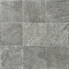 Fototapeta premium Close up of natural rough grey slate stone tiles with dark abstract veins. Honed and rough outdoor stone cladding tiles wall. Seamless background texture.