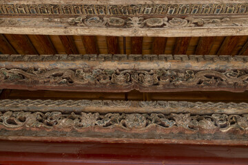 Ornate carved wooden eaves of an ancient temple in Gansu, China © PhungBao