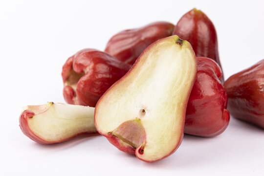 Red wax apples with sliced half isolated on white background
