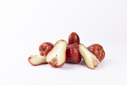 Whole and Cut Red Wax Apples Isolated on White Background