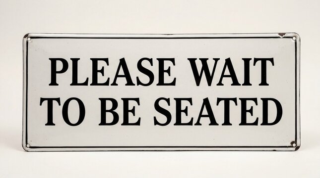 A sign instructs customers to wait to be seated in a restaurant or cafe