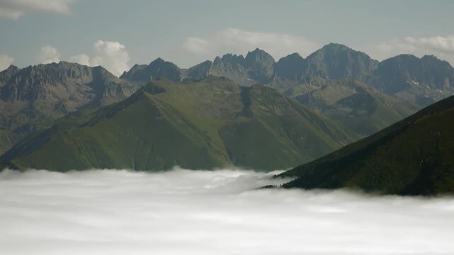 Kackar Mountains over mist blanket valley panorama, summer alpine terrain near Rize, Turkey. Pontic Alps peaks above cloud inversion basin, warm season vista, Black Sea region Anatolia.