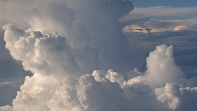 white and grey cumulus clouds, view fro aside from an airplane 