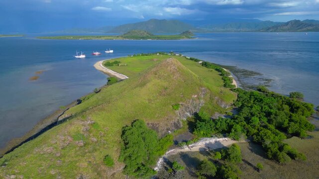speed ramp Pulau kenawa hills island, boats anchoring Smooth aerial view drone