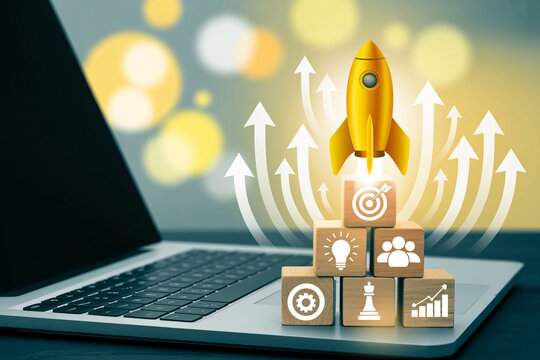 A yellow rocket launching from wooden blocks on a laptop keyboard with white arrows