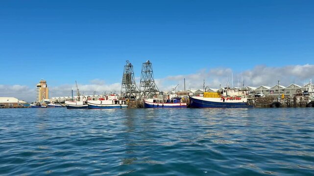 Cape Town, South Africa - January 31, 2026: Hop-on hop-off water boat tour at Cape Town&rsquo;s VA Waterfront, sunny weather, blue sky, relaxed holiday atmosphere with tourists enjoying harbor views. 