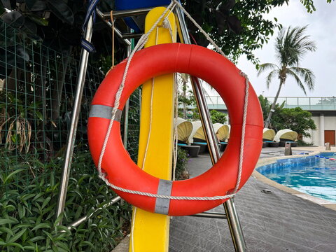 Orange safety buoy circe near the swimming pool.