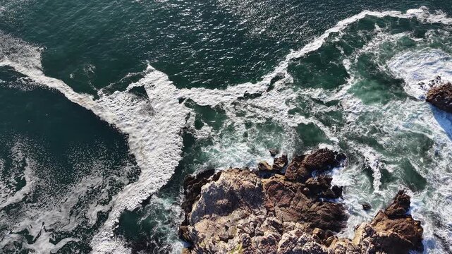 Hermanus, South Africa - January 19, 2026: Aerial drone view of Hermanus from the ocean, waves rolling along the coastline, clear blue sky and scenic seaside town in South Africa.