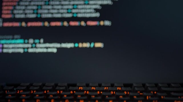 Professional programmer views AI model on computer screen as it dynamically produces precise code, illustrating automation software innovations in technological advancements in coding and engineering