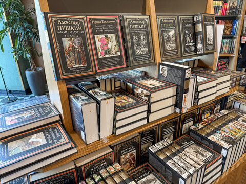 Saint Petersburg, Russia - April 27, 2026: Books authored by Alexander Pushkin are arranged on wooden shelves in a bookstore, showcasing various titles and illustrations