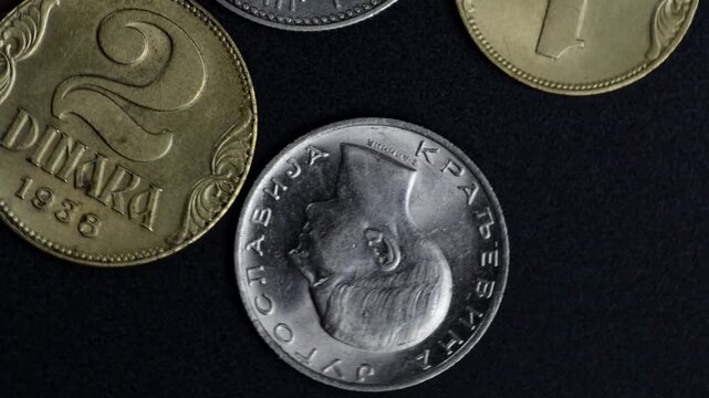 Vintage Kingdom of Yugoslavia Coins Rotating on Black Background, Historical Currency, Wealth and Numismatics Concept