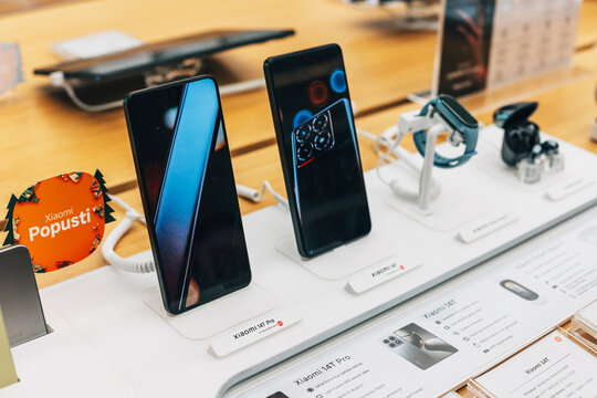 29 December 2024, Belgrade, Serbia: Xiaomi 14T Pro smartphones and smartwatches on display in a modern electronics store, highlighting new technology