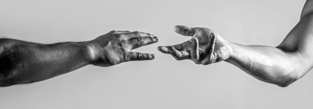 Hands reaching towards each other. Hands of man and woman reaching to each other. Two hands, helping arm friend, teamwork, support. Black and white