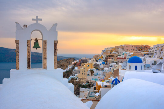 Oia town on Santorini island, Greece. Traditional and famous houses and churches with blue domes over the Caldera, Aegean sea