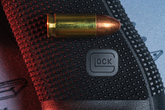 BALTIC STATES &mdash; May 4, 2026: Macro view of the new Gen 6 Glock pistol grip texture with a 9mm round on a technical mat.