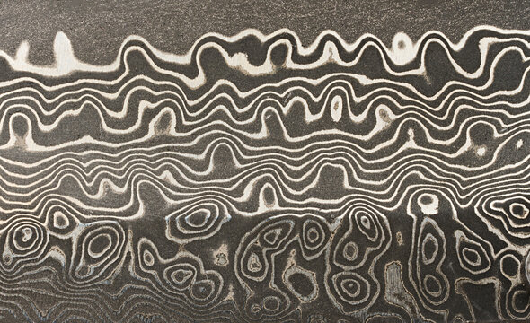 Macro surface of the Damascus steel blade with a unique wavy pattern