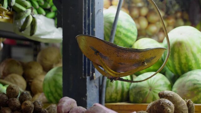 Vintage weighing scale swinging at farmers' market stall
