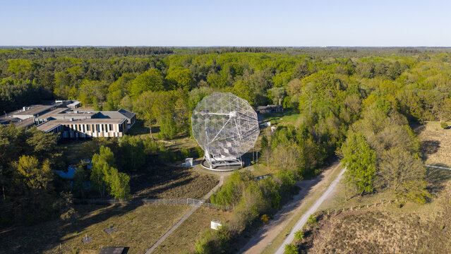 Aerial view of the Radiotelescoop at the Dwingeloo Radio Observatory surrounded by dense green forest and modern research facilities Dwingeloo, Drenthe, Netherlands.