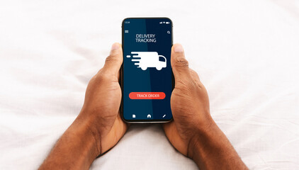 Naklejka premium Track Your Order Online. Point of view of black man holding and using his smartphone with delivery tracking service application, checking status of domestic and international shipments via internet