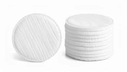 Obraz premium Two Piles Of White Round Cotton Pads For Cosmetic Use On A White Background