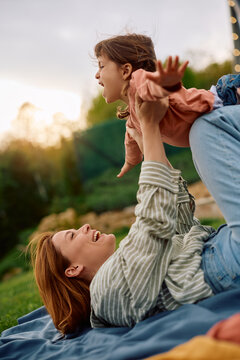 Carefree little girl having fun with her mother at park.