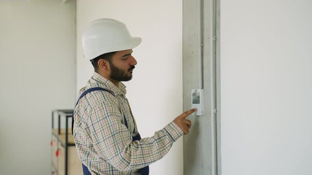 Technician installing smart home temperature control system