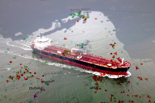 Oil tanker navigating the Strait of Hormuz with maritime traffic overlay