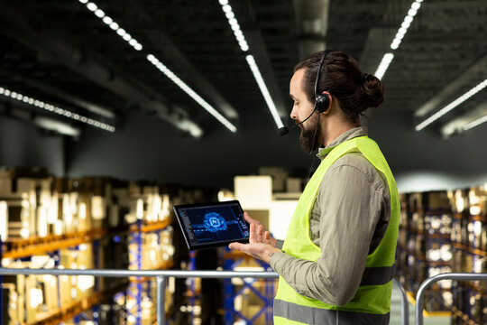 Logistics employee, headset and tablet, AI systems, customer service operations, working in warehouse fulfillment center. Artificial intelligence with neural networks for delivery parcel status.
