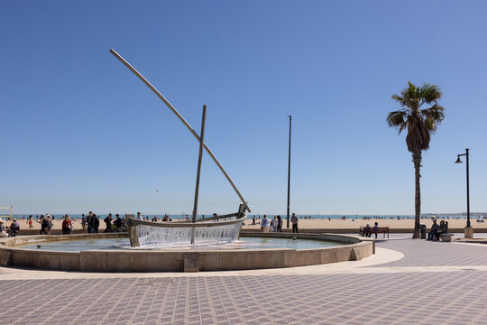 fountain at pedestrian walkway at the beach in Valencia, Spain on sunny afternoon with blue sky