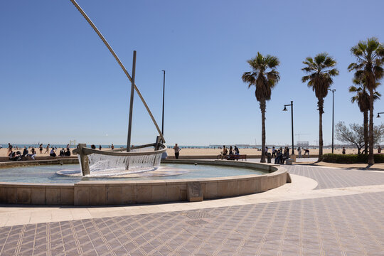 fountain at pedestrian walkway at the beach in Valencia, Spain on sunny afternoon with blue sky