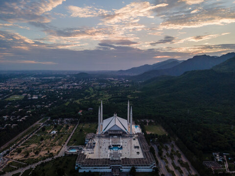 Aerial view of Faisal Masjid and its white minarets at the foot of the Margalla Hills during sunset in Islamabad, Islamabad Capital Ter, Pakistan.