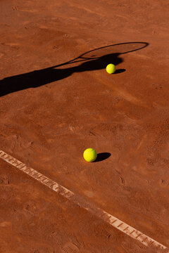 clay tennis court in europe with shadow of tennis player holding racket