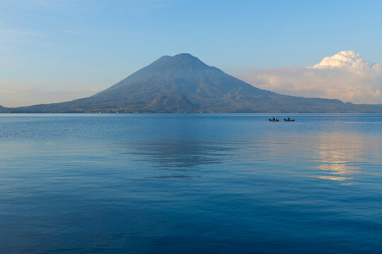 Atitlan Lake at sunrise with two fishermen silhouettes, Panajachel, Guatemala.