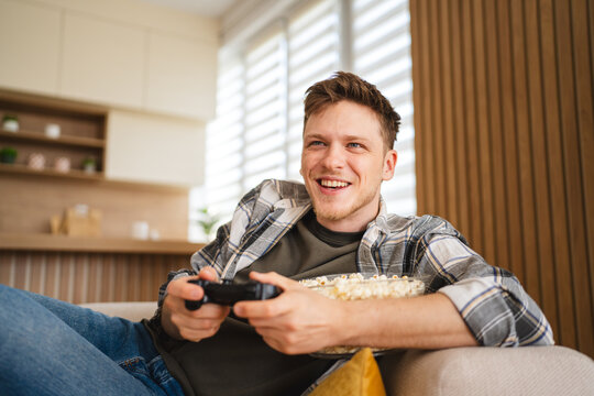 Young man enjoying video gaming lifestyle at home