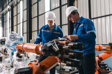 Robot arm worker engineer auto manufacturing factory teamwork inspection industrial technology safety helmet uniform mechanic technician man machine automation modern equipment assembly line © chokniti