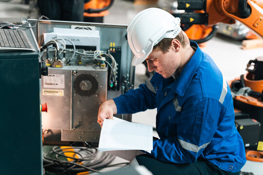 Repair specialist inspects machinery in factory ensuring industry standards with spare parts for maintenance and safety compliance in modern industrial environment